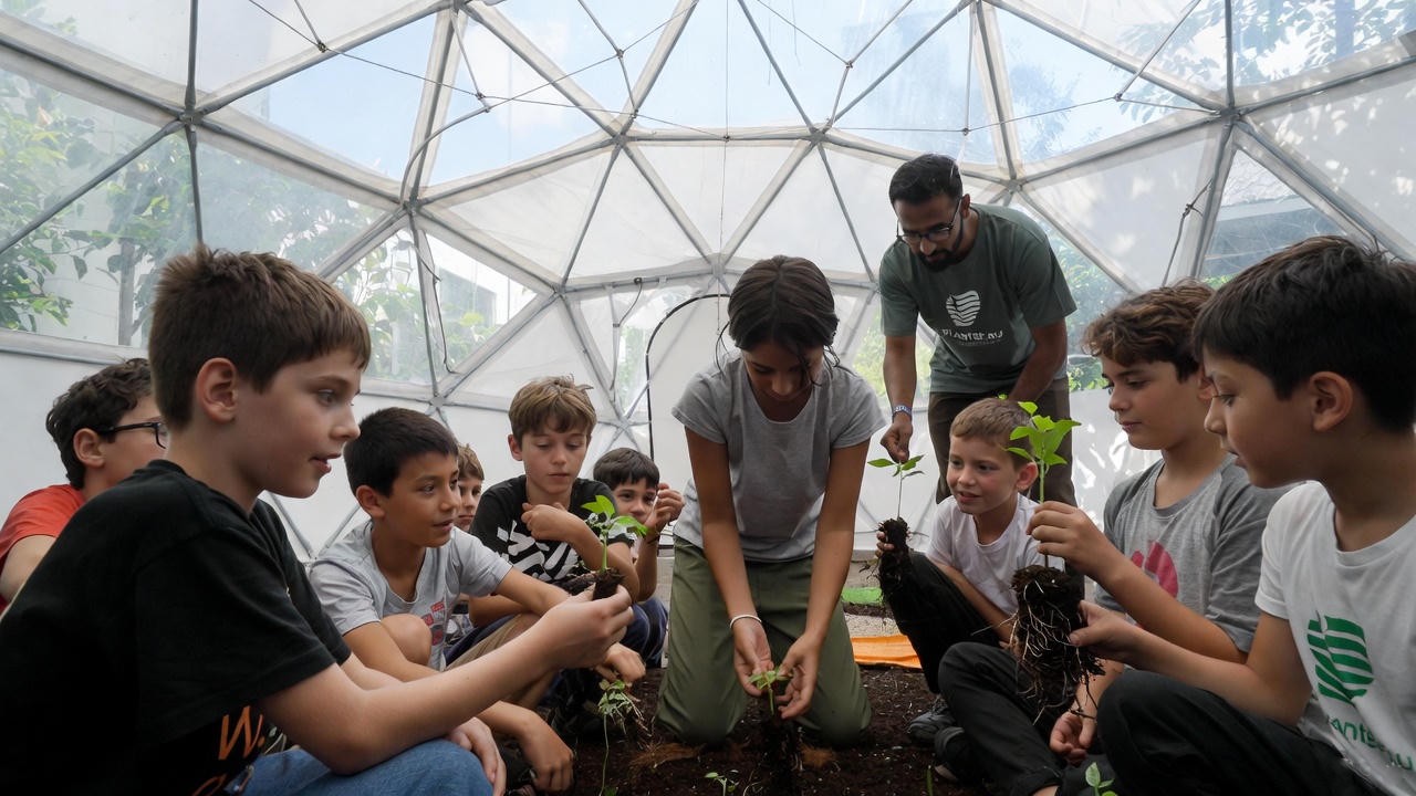 Children learning to plant seedlings inside a geodesic dome classroom in Mauritius
